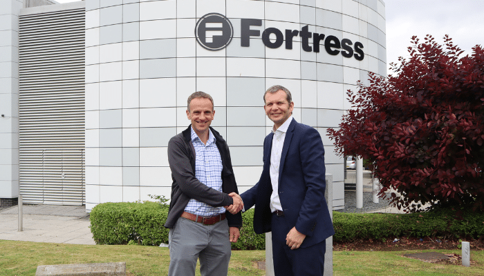 Managing Directors of Remlive and Fortress Safety shaking hands, marking the strategic acquisition of Remlive by Fortress Safety.