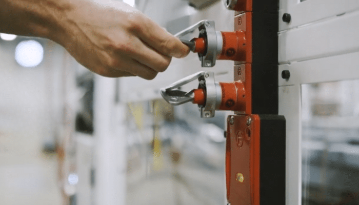 Red amGardpro safety unit with trapped keys mounted on metal guarding