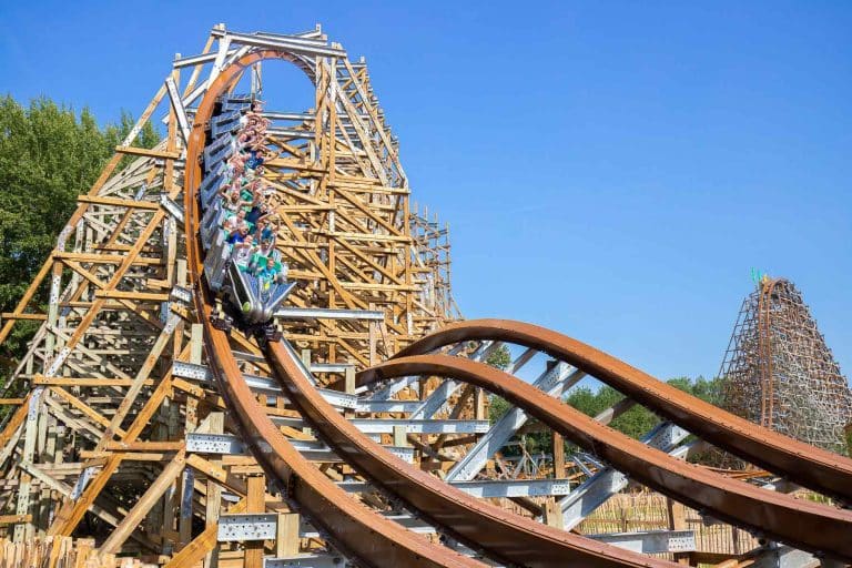 The Untamed roller coaster in motion with riders enjoying the experience.