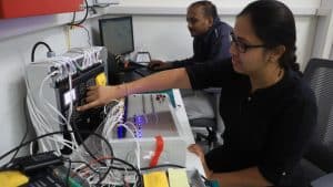 Female engineer working on industrial machinery in a manufacturing environment