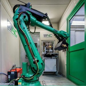 Inside view of large green ABB robot arm behind green guarding with window and amGardpro unit.