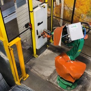 Inside view of green and orange AIC robot arm behind yellow guarding with mounted amGardpro unit.