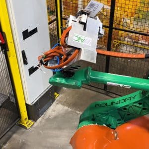 AIC green robot arm behind yellow guarding with mounted amGardpro safety unit.